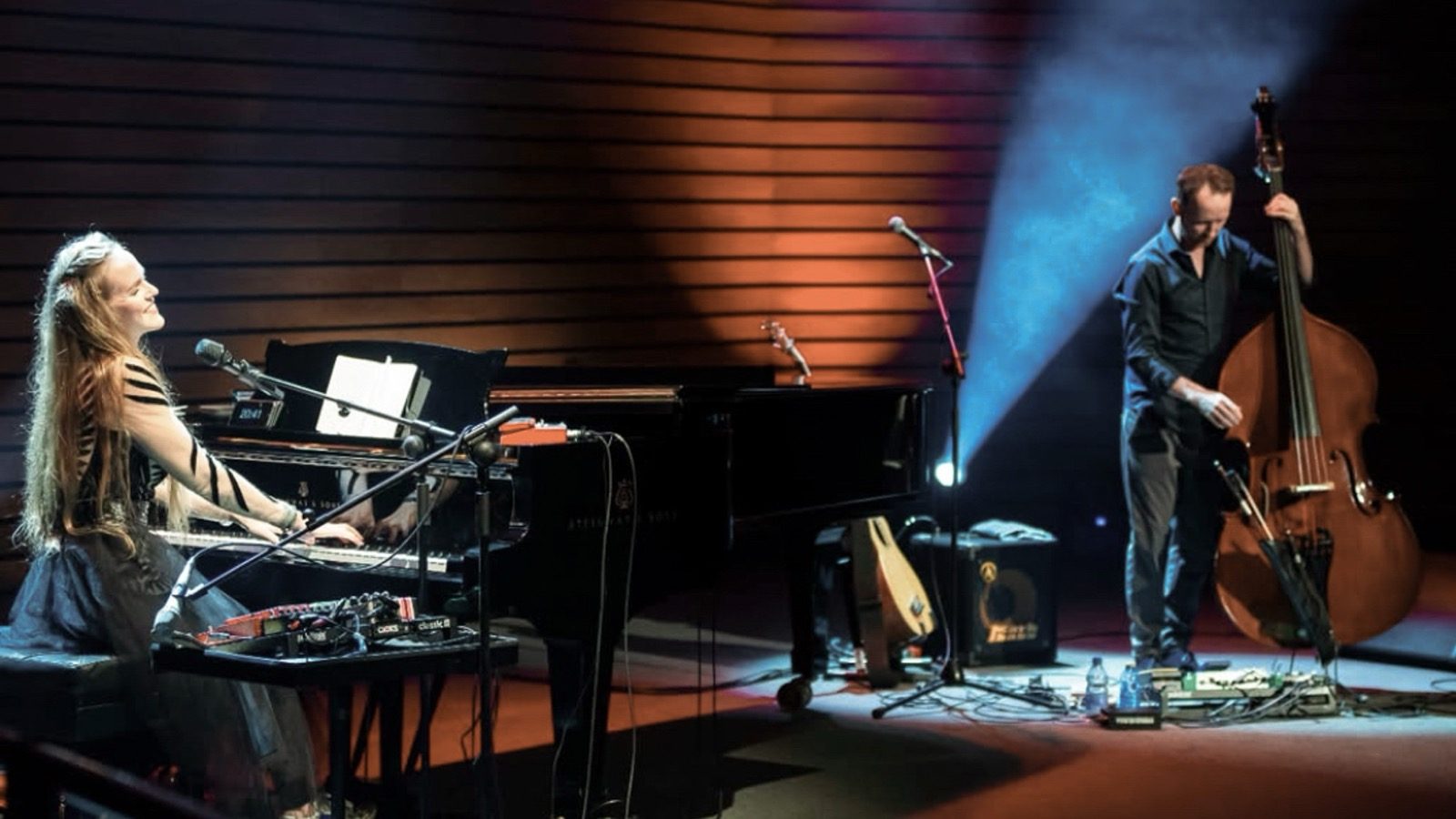 Kadri Voorand and Mihkel Mälgand performing onstage with piano and double bass